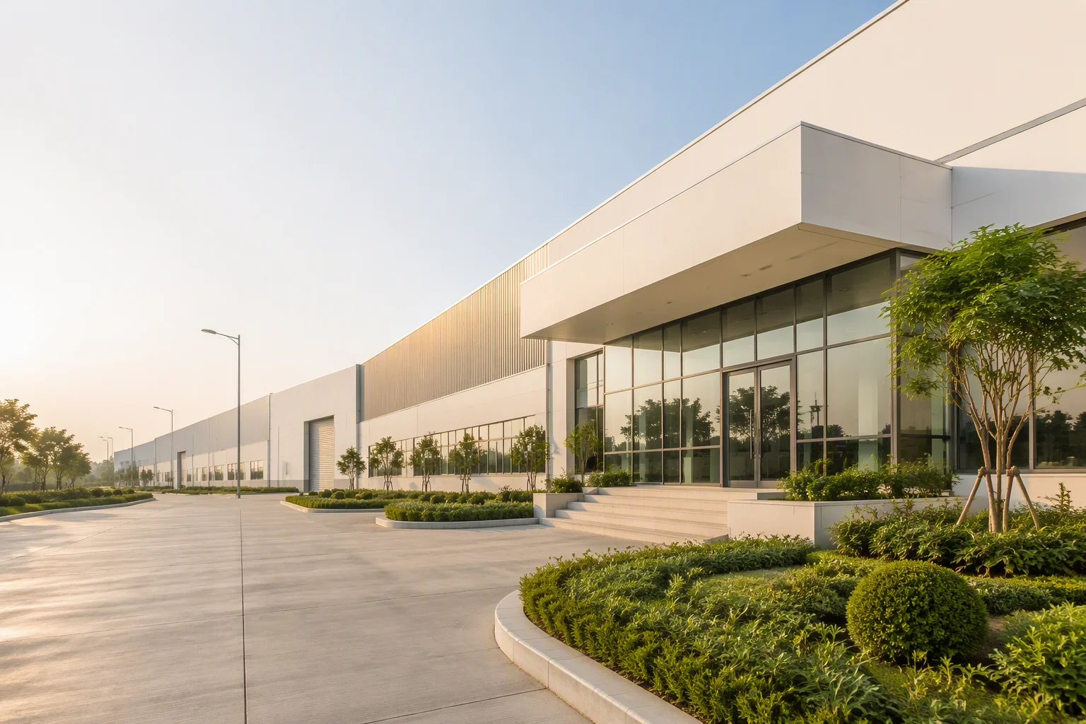 Modern factory building exterior with green landscaping